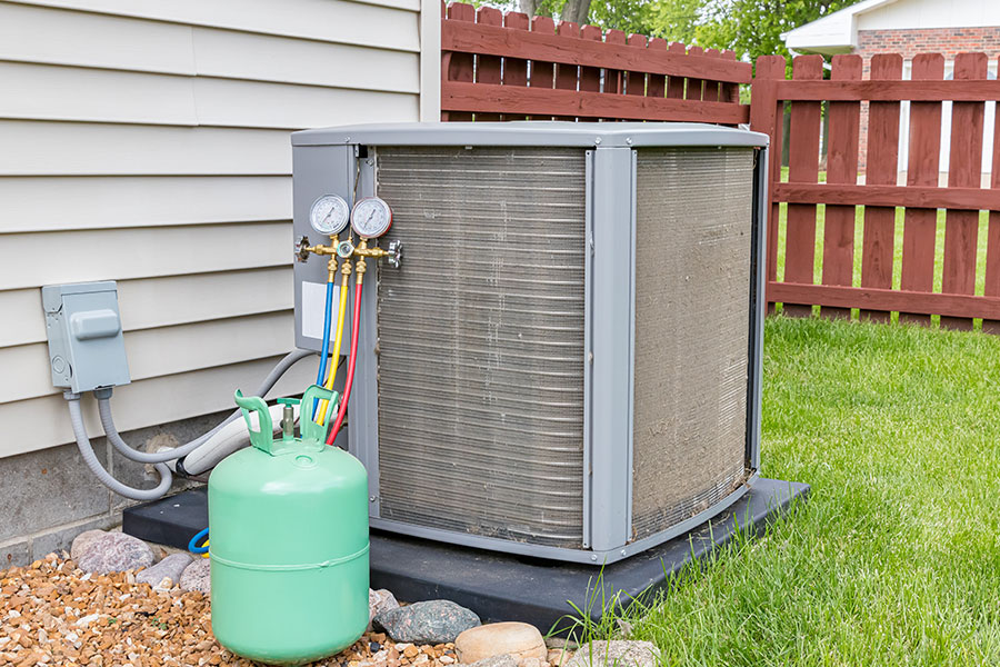 An outside view of an air conditioning unit that needs to be inspected by a professional HVAC technician in the Metro East.